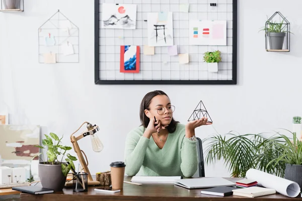 Dreamy African American Interior Designer Holding Model Pyramid Home Studio — Stok Foto