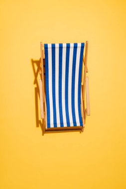 top view of striped deck chair on yellow clipart