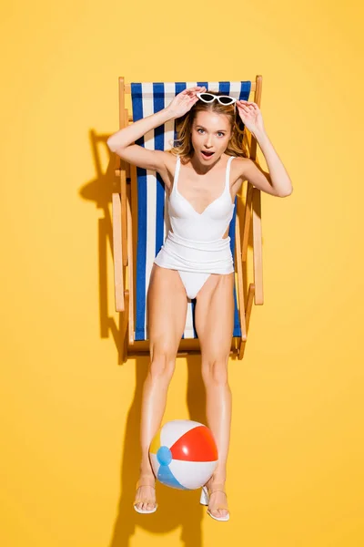 Top View Amazed Woman Touching Sunglasses While Sitting Deck Chair — Stock Photo, Image