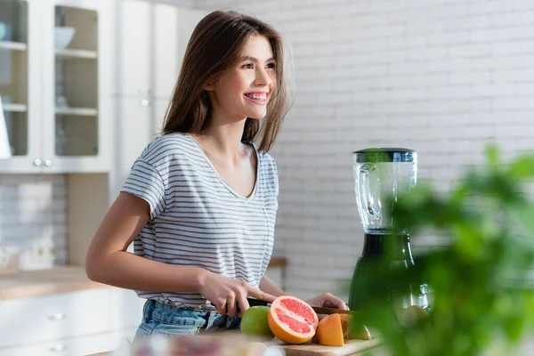 Happy Woman Cutting Fresh Fruits While Preparing Breakfast Blurred Foreground — Stock Photo, Image