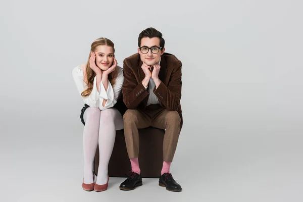 Happy Couple Retro Clothes Looking Camera While Sitting Suitcase Grey — Stock Photo, Image