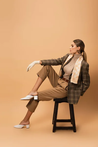 Side View Pretty Woman Trendy Blazer Pants Sitting Wooden Stool — Stock Photo, Image