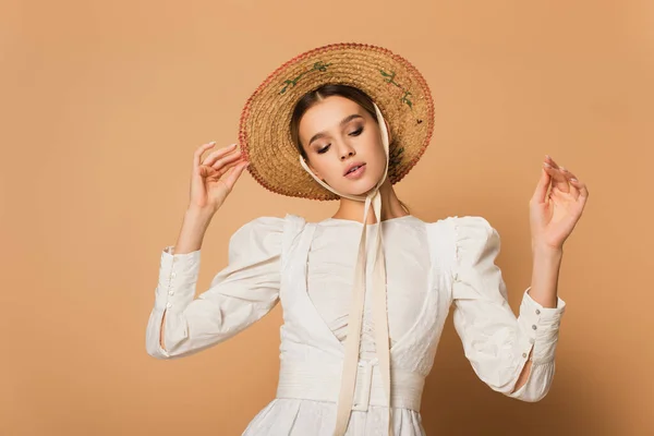 Young Woman White Dress Adjusting Straw Hat Beige — Stock Photo, Image