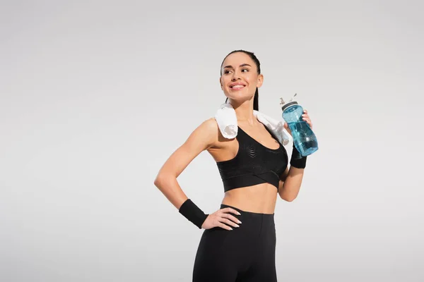 Happy Sportswoman Towel Shoulders Holding Sports Bottle While Posing Hand — Stock Photo, Image