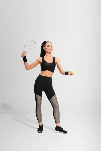 Full Length Positive Sportswoman Holding Tennis Racket Ball While Playing Stok Gambar