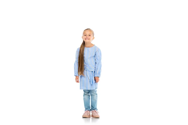 Cheerful kid smiling while standing on white background — Stock Photo