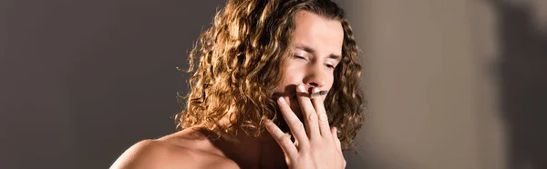 Sexy shirtless man with long hair smoking on dark background, banner — Stock Photo