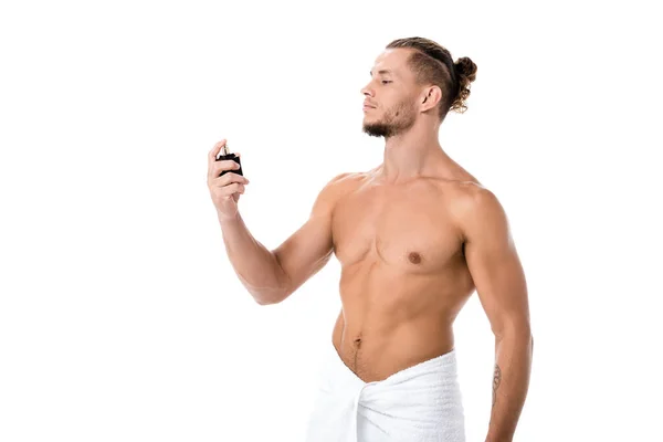 Sexy shirtless man in towel with perfume isolated on white — Stock Photo