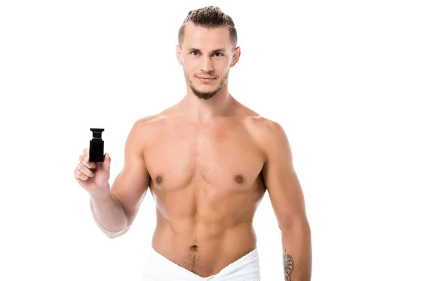 Sexy shirtless man in towel with perfume isolated on white — Stock Photo