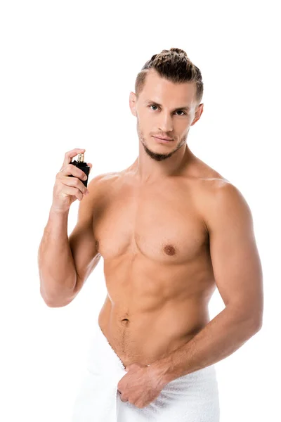 Sexy shirtless man in towel with perfume isolated on white — Stock Photo