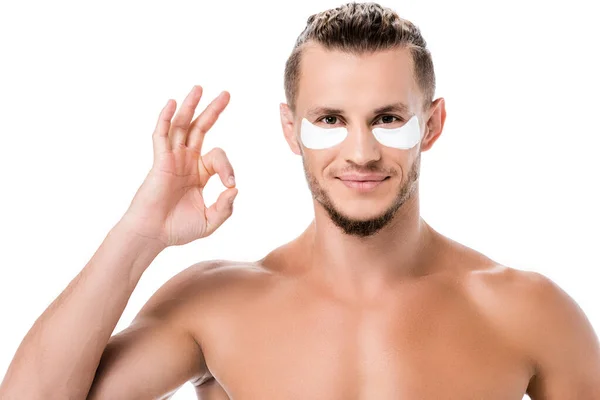 Sexy shirtless man eye patches on face showing ok isolated on white — Stock Photo