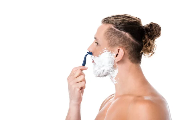 Side view of sexy shirtless man with foam on face shaving isolated on white — Stock Photo