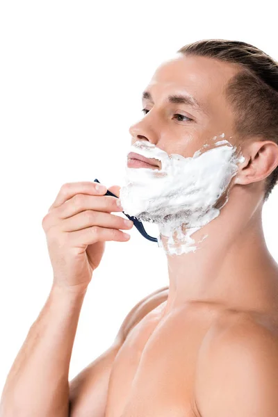 Sexy shirtless man with foam on face shaving isolated on white — Stock Photo