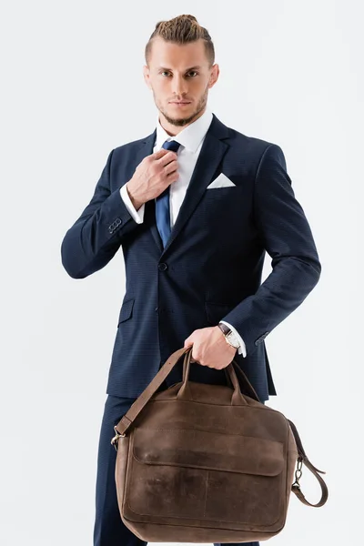 Young businessman in suit with suitcase isolated on white — Stock Photo