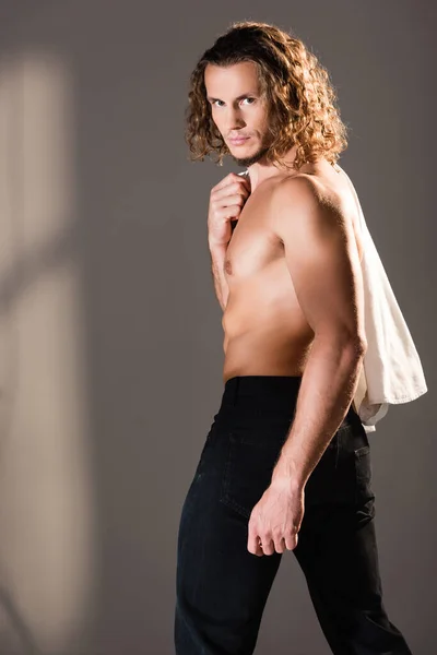 Sexy shirtless man with long hair posing on dark background — Stock Photo