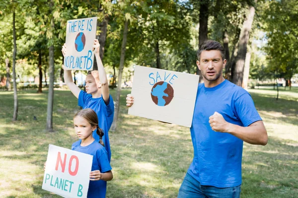 Family of volunteers holding placards with globe and there is no planet b inscription, ecology concept — Stock Photo