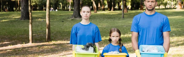Family of volunteers holding containers full of plastic rubbish, ecology concept, banner — Stock Photo
