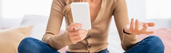 Ausgeschnittene Ansicht des Smartphones in der Hand einer Frau auf verschwommenem Hintergrund, Banner — Stockfoto