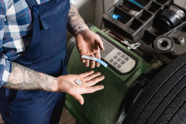 Vista parcial de la raya de sujeción mecánica tatuada con placas de equilibrio metálicas cerca de la máquina de control de equilibrio - foto de stock