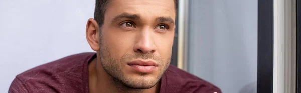 Pensive man looking away near open window, banner - foto de stock