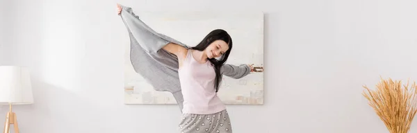 Happy woman with vitiligo with outstretched hands in bedroom, banner — Stock Photo