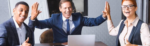 Happy businessman giving high five to multicultural colleagues with thumbs up at workplace in meeting room, banner — Stock Photo