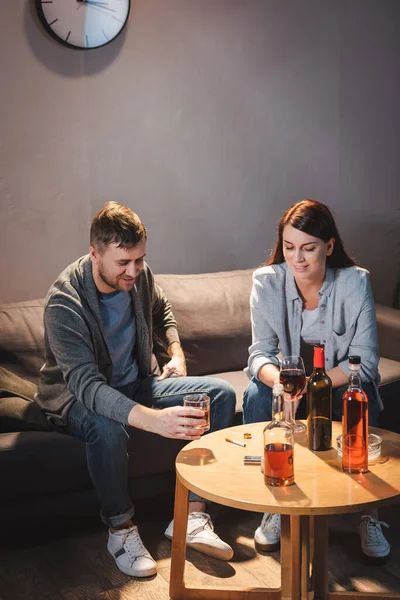 Alcohol-addicted husband and wife drinking alcohol at home together — Stock Photo