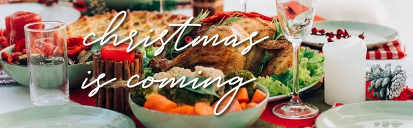 Table served with delicious pie, roasted turkey and vegetables near christmas is coming lettering near candles, banner — Stock Photo