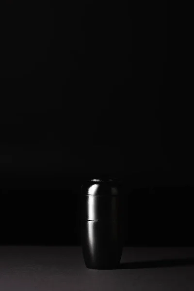 Urn with ashes on black background, funeral concept — Stock Photo