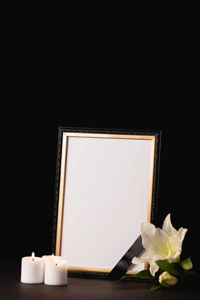 Lily, candle and mirror with ribbon on black background, funeral concept — Stock Photo