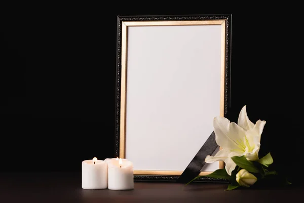 Lily, candle and mirror with ribbon on black background, funeral concept — Stock Photo