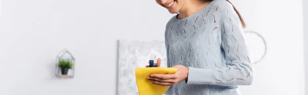 Cropped view of smiling woman applying detergent on rag, banner — Stock Photo
