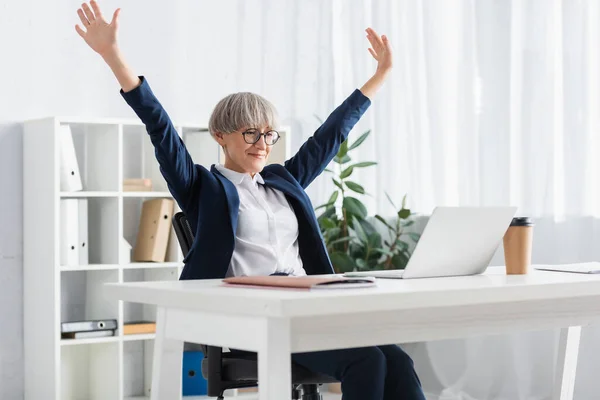 Joyful team leader in glasses celebrating triumph in office — Stock Photo