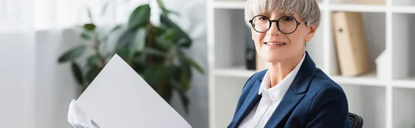 Happy team leader in glasses holding folder with documents, banner — Stock Photo