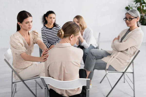 Young multicultural women supporting each other during seminar — Stock Photo