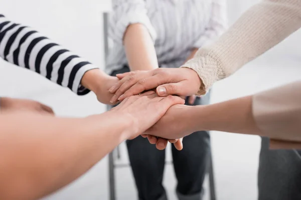 Partial view of group of women holding hands together during seminar — Stock Photo