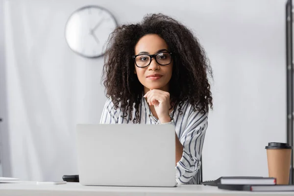 African american freelancer in glasses using laptop at home — Stock Photo