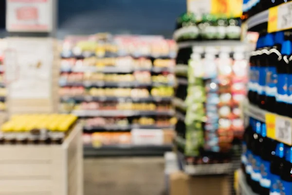 Blurred background of food on shelves in supermarket — Stock Photo