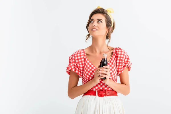 Glückliche Pin-up-Frau schaut weg, während sie eine Flasche Limo isoliert auf weiß hält — Stockfoto