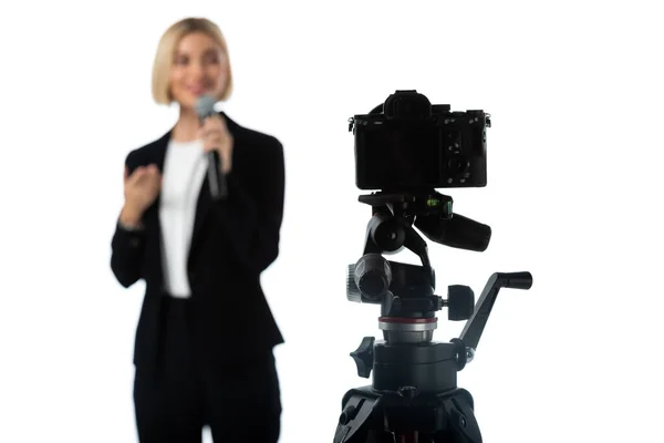 Selective focus of professional digital camera near news presenter on blurred background isolated on white — Stock Photo