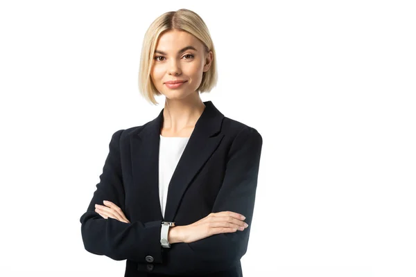 Positive blonde businesswoman with crossed arms looking at camera isolated on white — Stock Photo