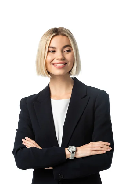 Happy businesswoman with crossed arms smiling while looking away isolated on white — Stock Photo