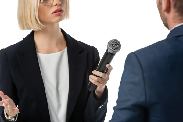 Cropped view of young news anchor taking interview from businessman isolated on white, blurred foreground — Stock Photo