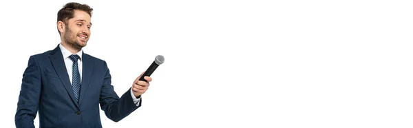 Smiling news commentator holding microphone isolated on white, banner — Stock Photo