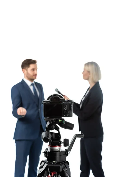 Selective focus of digital camera near reporter and businessman on blurred background isolated on white — Stock Photo