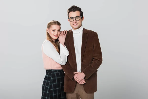 Young woman leaning on shoulder of man in velvet blazer isolated on grey — Stock Photo