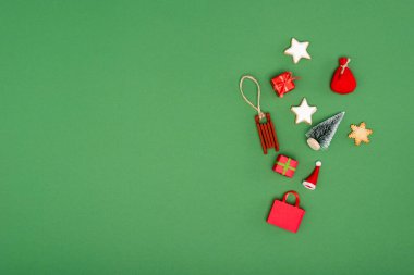 Yeşil zemin üzerinde farklı noel süsleri ve kurabiyeler fotokopi alanı