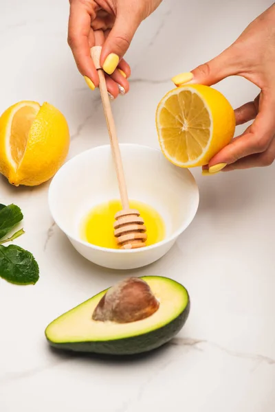 Cropped View Woman Mixing Honey Lemon Cut Avocado Rose Leaves — Stock Photo, Image