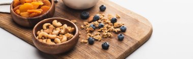 delicious granola with nuts,dried apricots and blueberry on white background, banner clipart