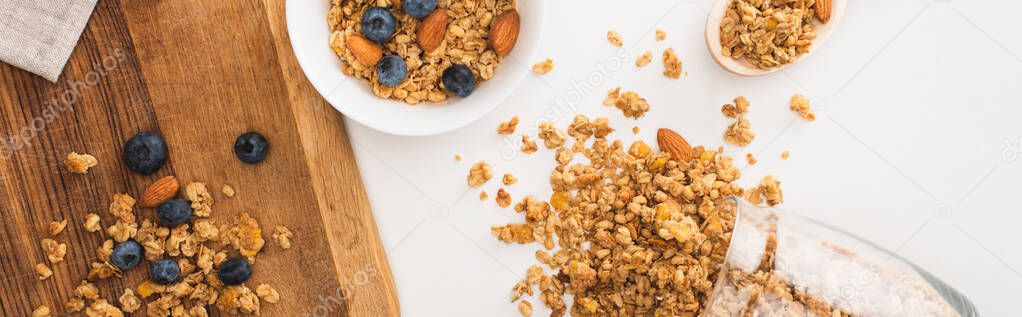top view of delicious granola with nuts, blueberry and dried apricots isolated on white, banner